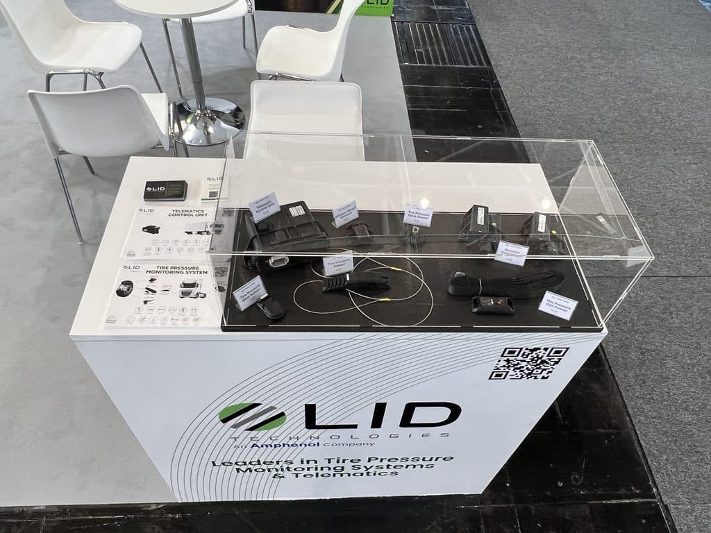 LID Technologies product display case at IAA Transportation, featuring TPMS sensors and Telematics Control Unit